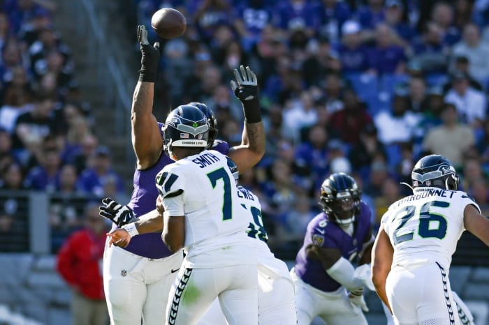 Baltimore Ravens defensive tackle Travis Jones (98) blocks Seattle Seahawks quarterback Geno Smith (7) first half pass during the first half at M&T Bank Stadium.